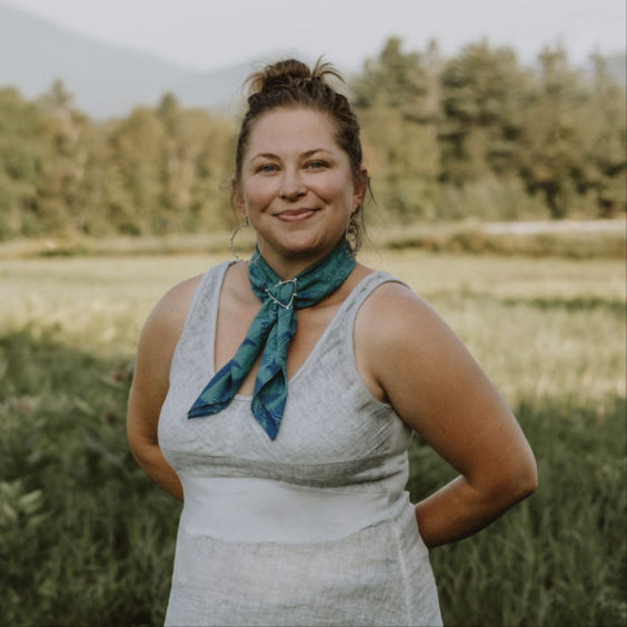 shannon wisdom river designs in a field with a bandana slide and blue trout bandana