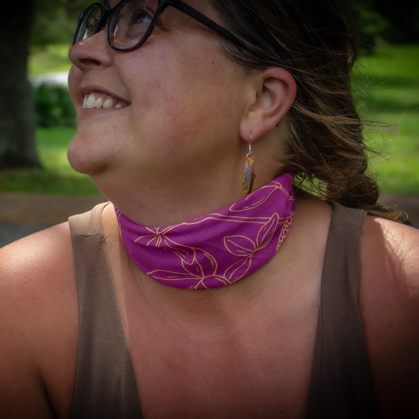 Pink bandana with clovers around woman's neck