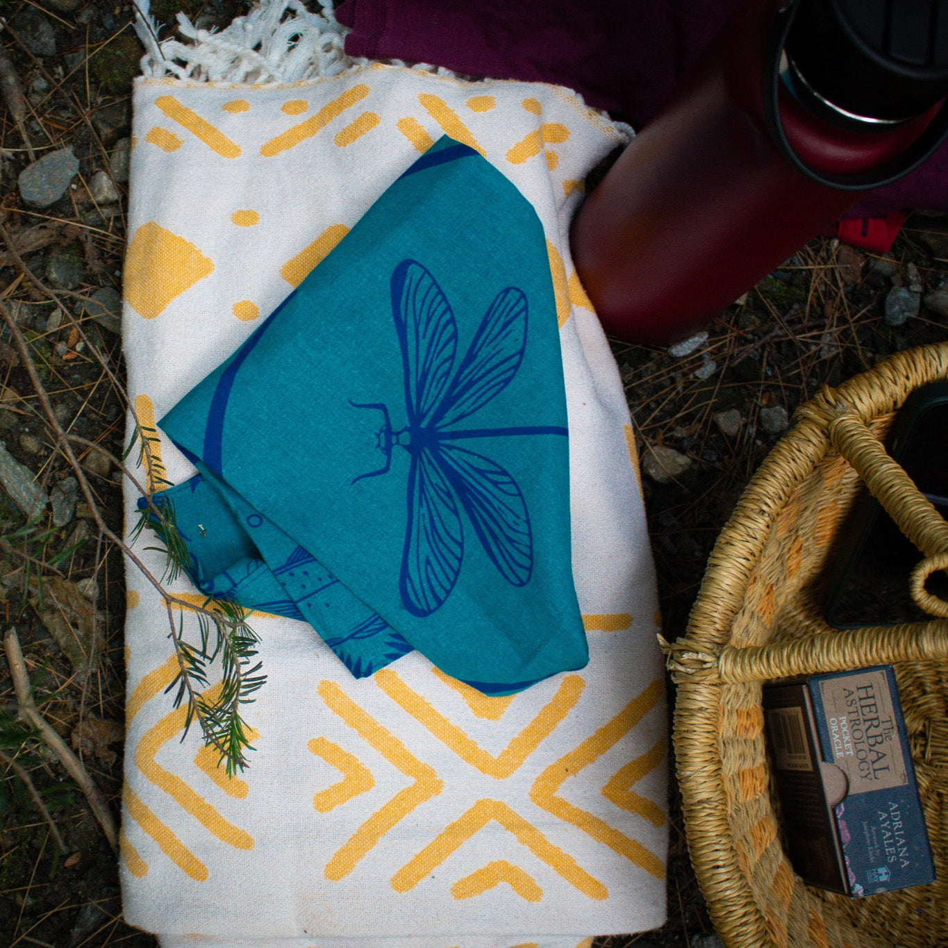 Dragonly blue bandana on a towel with herbal astrology cards